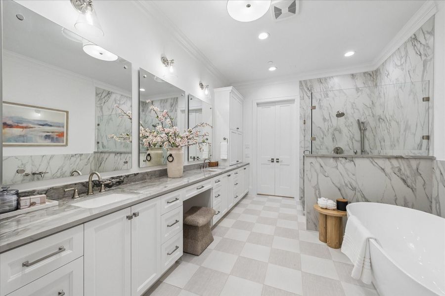 Dual sinks, seamless glass shower and standalone tub.