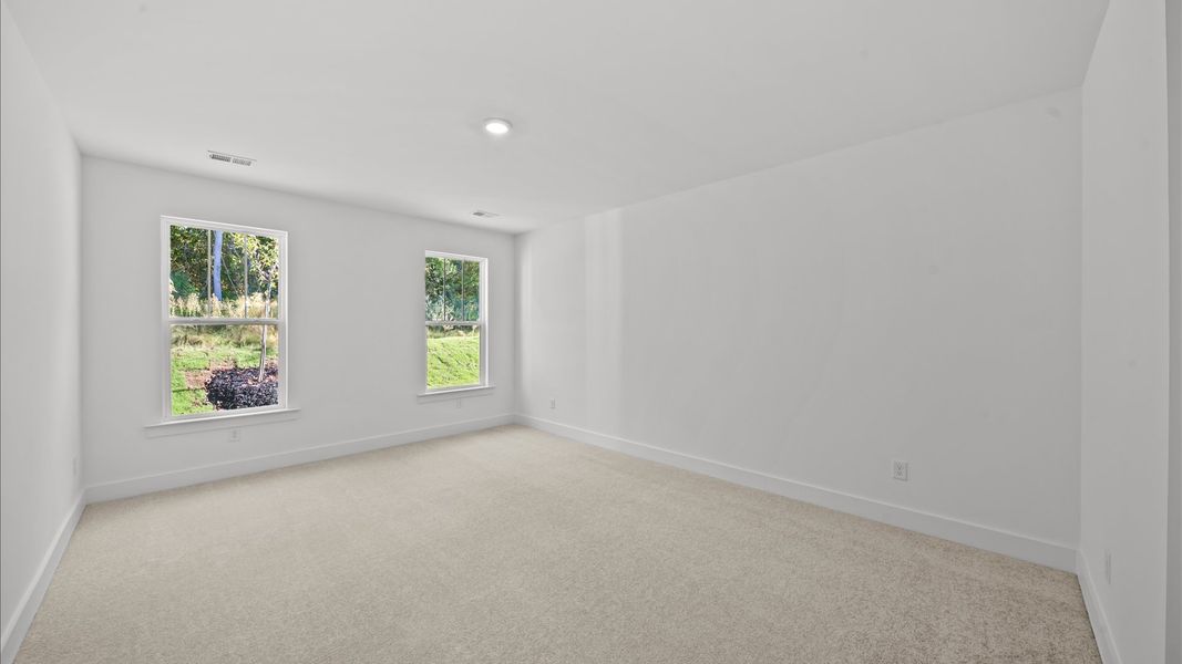 Eye-catching details and elegant finishes in the vibrant primary suite of this select home