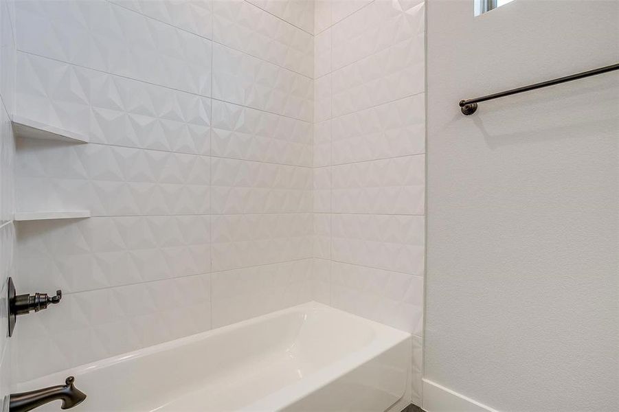 Bathroom featuring tiled shower / bath