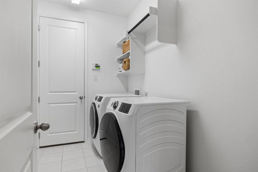 Laundry area featuring light tile patterned flooring and washer and dryer Laundry area featuring light tile patterned flooring and washer and dryer