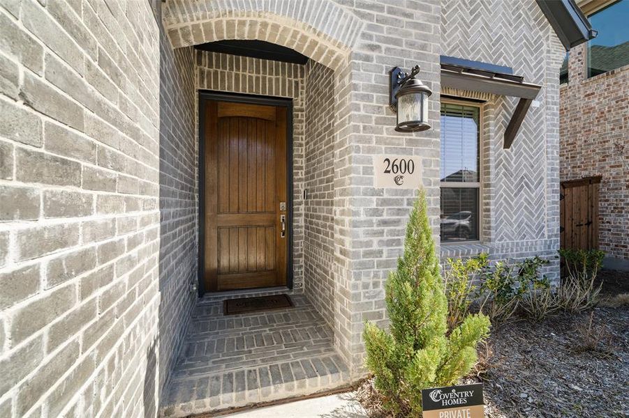 Exterior details and patio area of a home in Cambridge Crossing, Celina (Image 27).