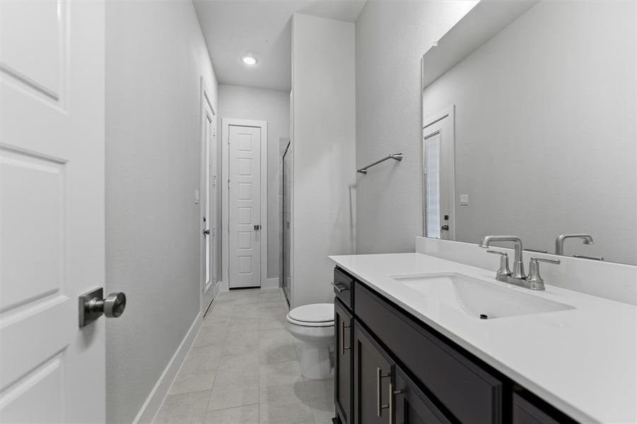 Bathroom with vanity, a shower stall, and recessed lighting