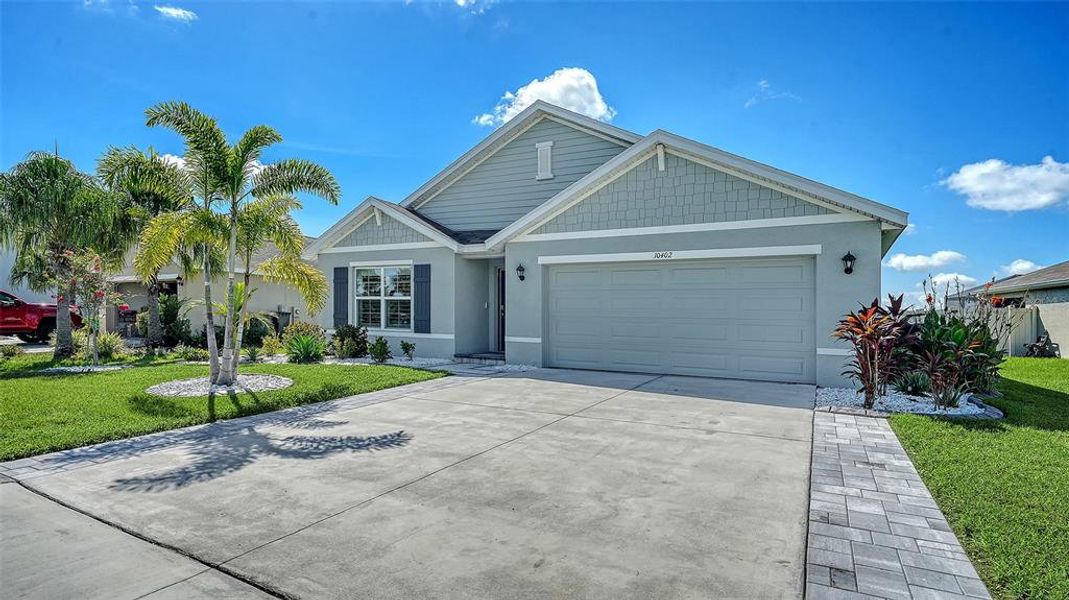 Front exterior of a new home in Bella Lago, Parrish, FL, highlighting curb appeal (Image 2). Front exterior of a new home in Bella Lago, Parrish, FL, highlighting curb appeal (Image 2).