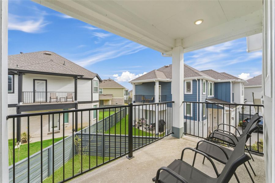 Spacious second-floor balcony with room for seating, offering a relaxing spot to unwind and enjoy neighborhood views.