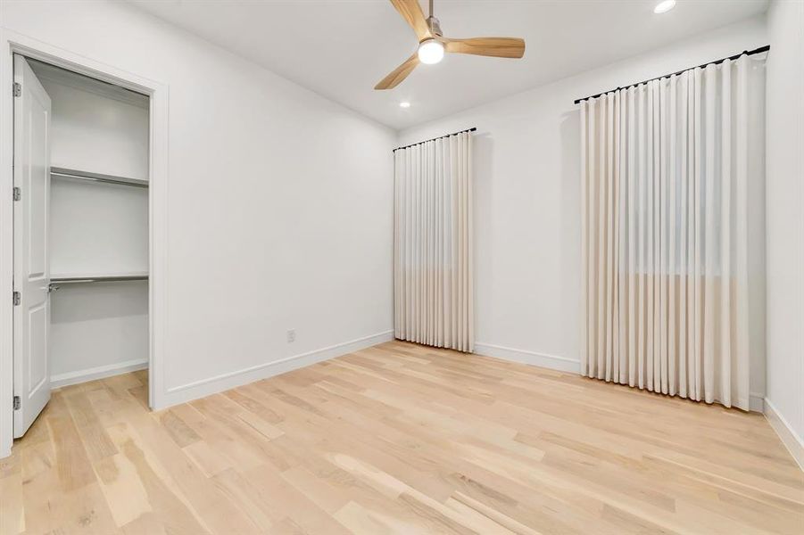 Unfurnished bedroom featuring light wood-style floors, a ceiling fan, recessed lighting, and a closet Unfurnished bedroom featuring light wood-style floors, a ceiling fan, recessed lighting, and a closet