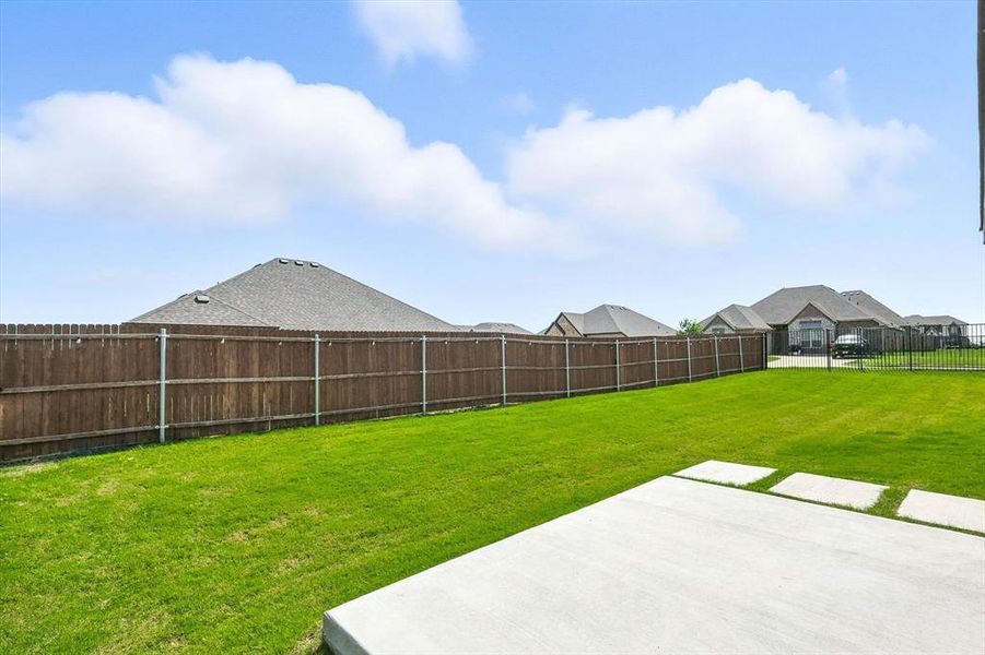 Fenced backyard with a patio and a residential view