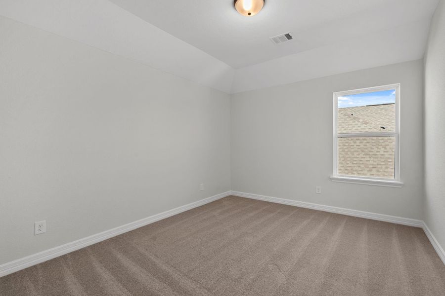 Your secondary bedroom features plush carpet, fresh paint, closet, and a large window that lets in plenty of natural lighting.