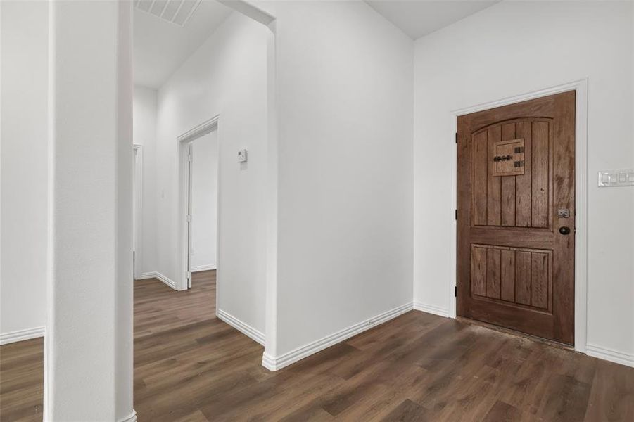 Entrance foyer featuring dark hardwood / wood-style floors