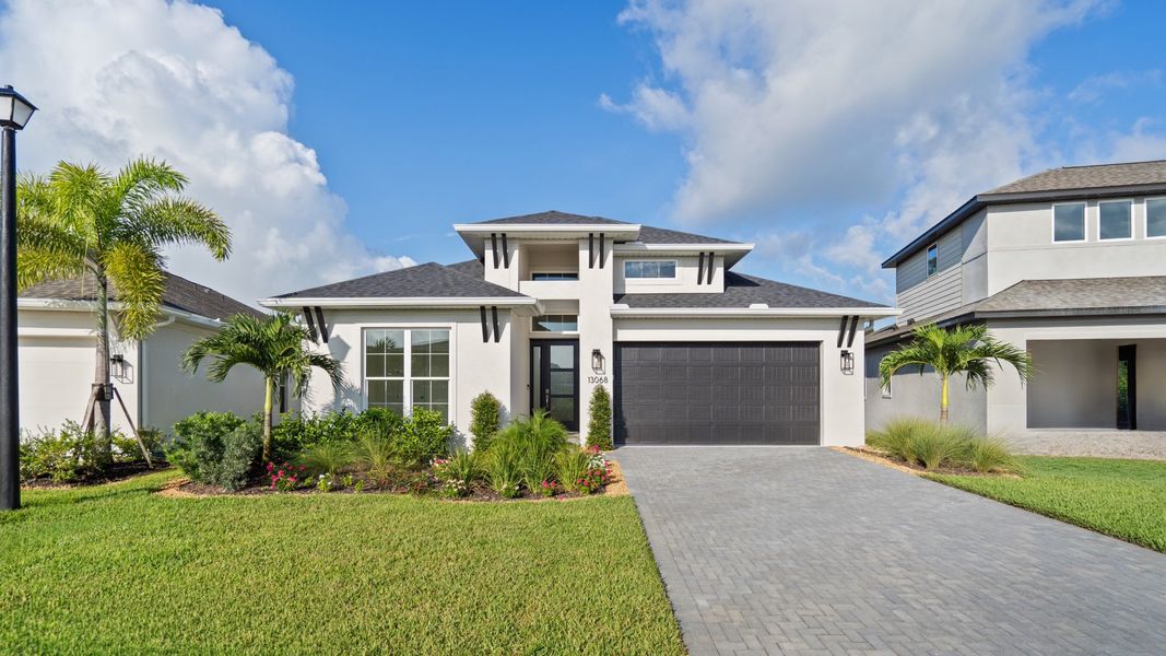 Front exterior of a new home in Turnleaf, Punta Gorda, FL, highlighting curb appeal (Image 1). Front exterior of a new home in Turnleaf, Punta Gorda, FL, highlighting curb appeal (Image 1).