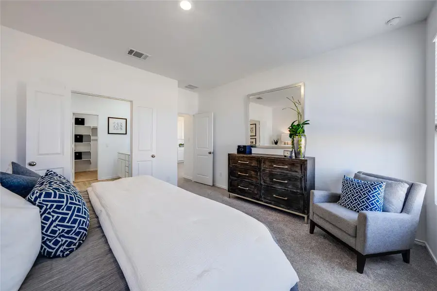 Bedroom with light carpet and ensuite bath