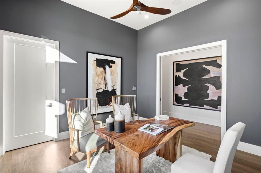 Beautiful home office with decorative glass pocket doors tucked away from the main living areas of the home.