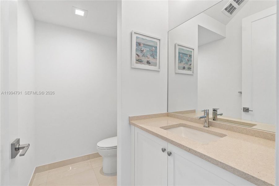 Guest half bath off foyer