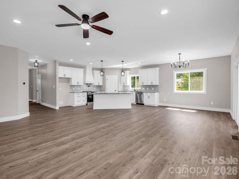 Open floor plan (kitchen, dining and living) hardwood floors, granite counters, sliders to covered screened porch Virtually Staged to allow buyers to envision the space Open floor plan (kitchen, dining and living) hardwood floors, granite counters, sliders to covered screened porch Virtually Staged to allow buyers to envision the space