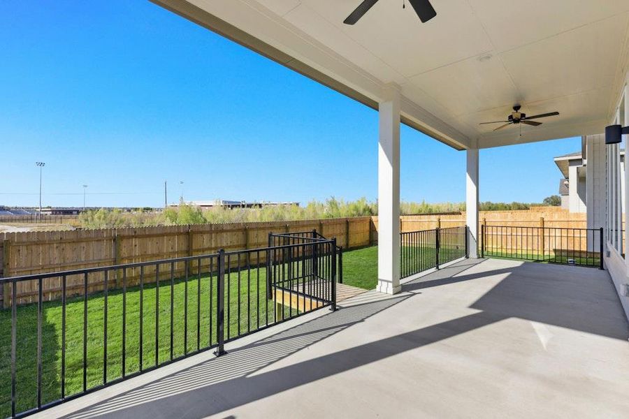 Fenced backyard featuring a ceiling fan and a patio area Fenced backyard featuring a ceiling fan and a patio area