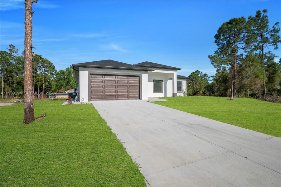 Front exterior of a new home in , Lehigh Acres, FL, highlighting curb appeal (Image 25).