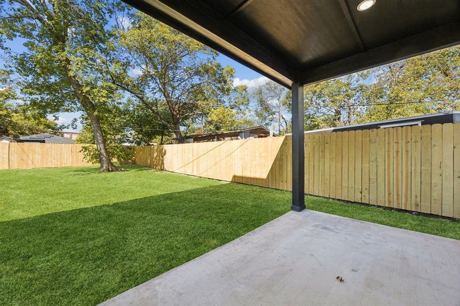 Fenced backyard featuring a patio
