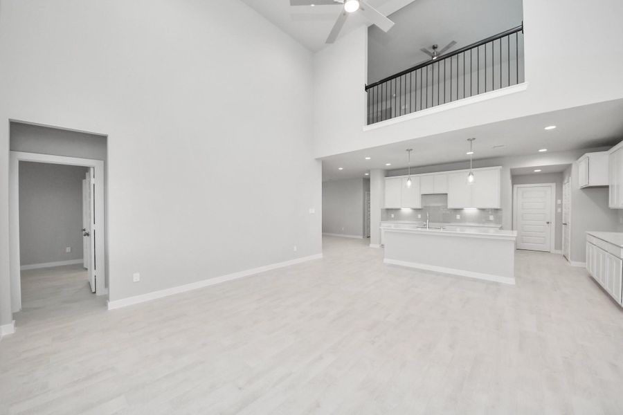 View from the living room area to the kitchen area. Sample photo of completed home with similar floor plan. Actual colors and selections may vary. View from the living room area to the kitchen area. Sample photo of completed home with similar floor plan. Actual colors and selections may vary.