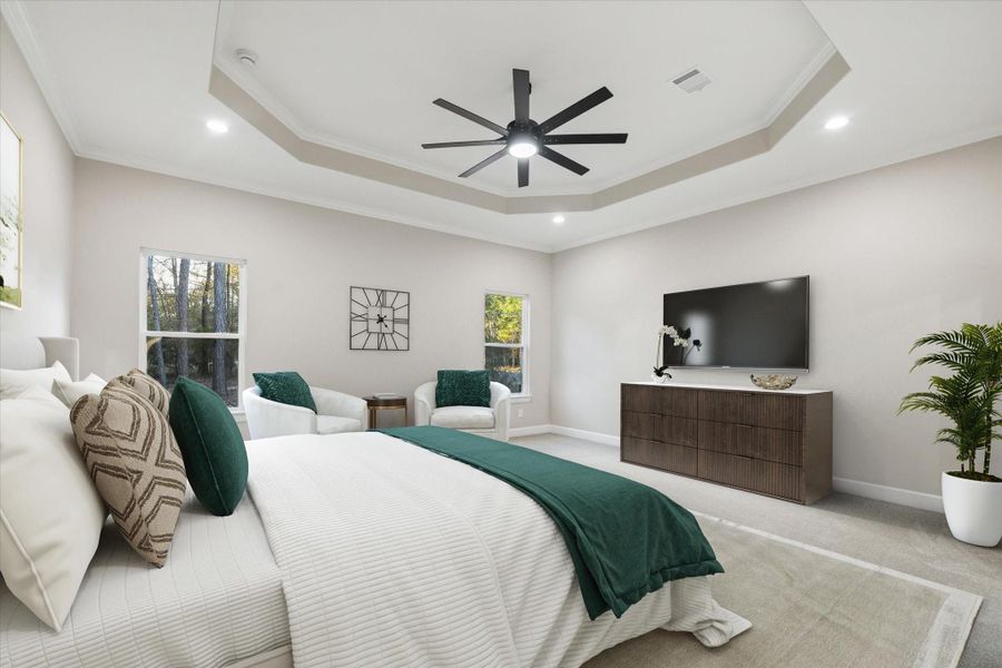 Virtually staged primary bedroom.  Inset ceiling with lighted ceiling fan and crown molding.  Two windows look to the rear of the home.