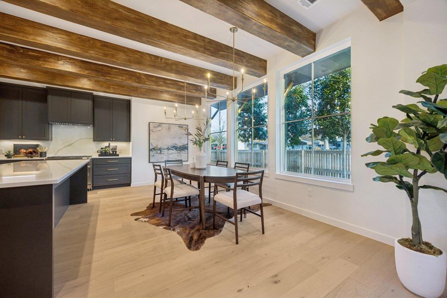 Nicely appointed dining area adjacent to the kitchen along a wall of windows!