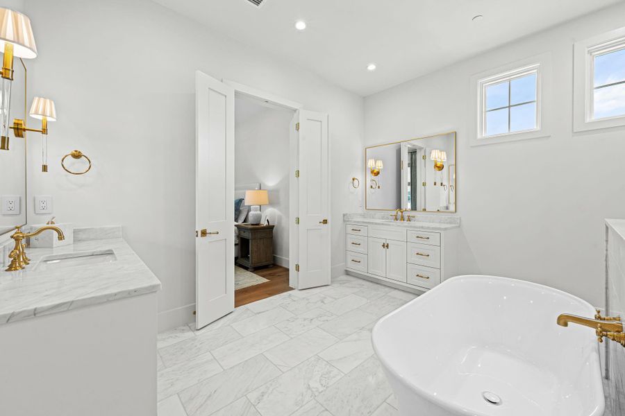Another view of the dream primary bath highlighting the two separate vanities. Not shown is the expansive primary closet, complete w/ a center island, built-in storage, window seat & direct access to the utility room for added convenience. Another view of the dream primary bath highlighting the two separate vanities. Not shown is the expansive primary closet, complete w/ a center island, built-in storage, window seat & direct access to the utility room for added convenience.