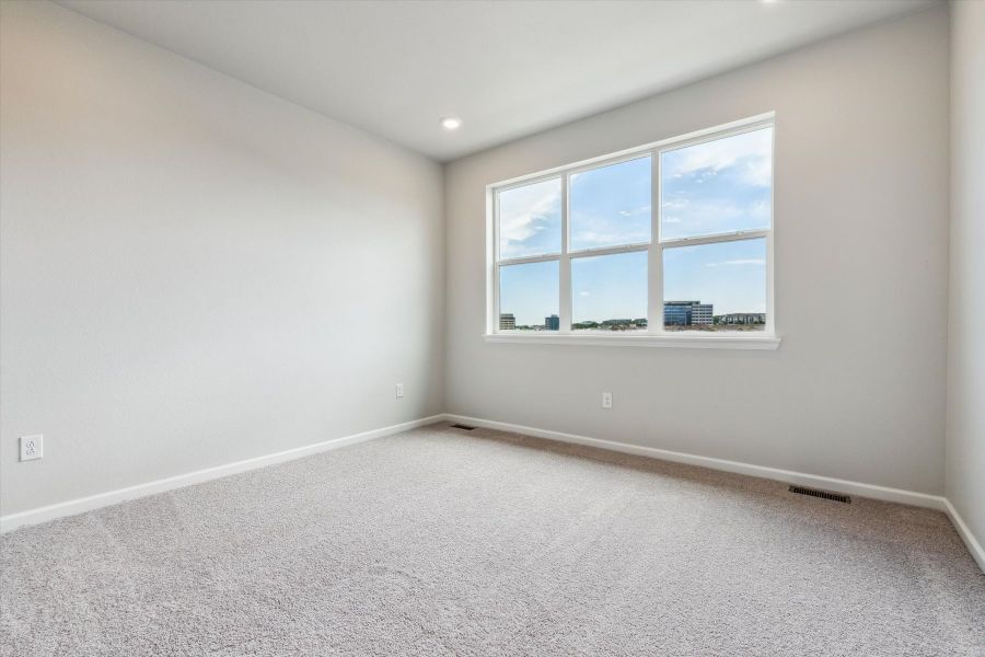 A room with a window and a white wall. A room with a window and a white wall.