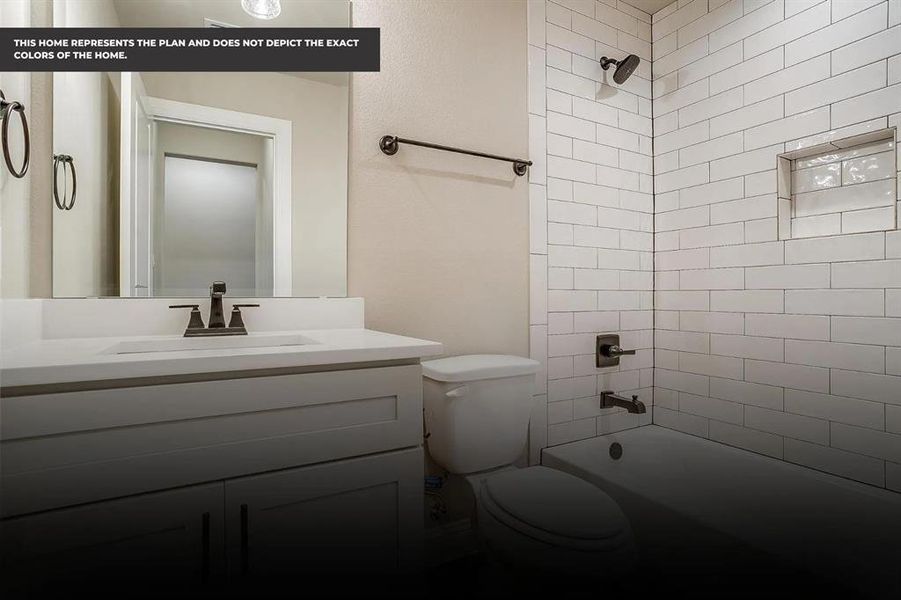 Full bathroom with vanity, tiled shower / bath combo, and toilet