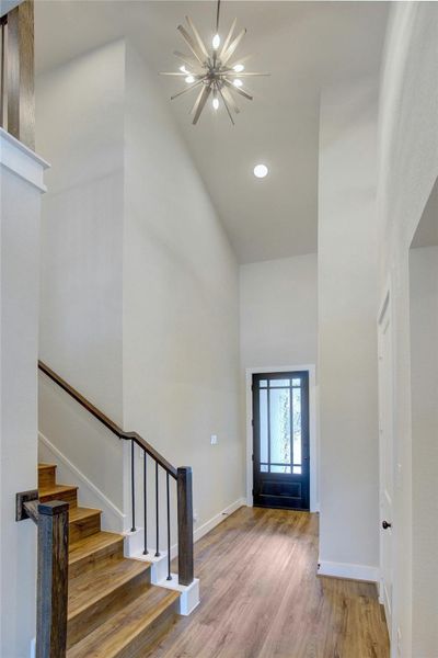 Vaulted entry way with wood floors throughout