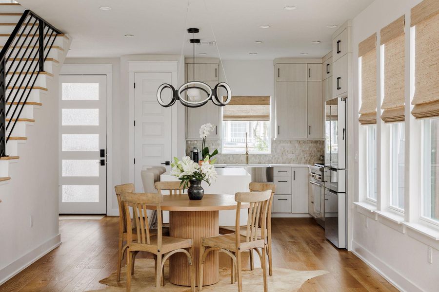 Dining area with light wood-style flooring and recessed lighting