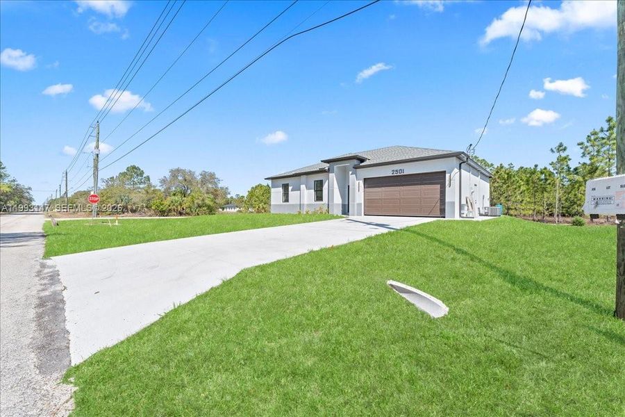 Front exterior of a new home in , Lehigh Acres, FL, highlighting curb appeal (Image 9).