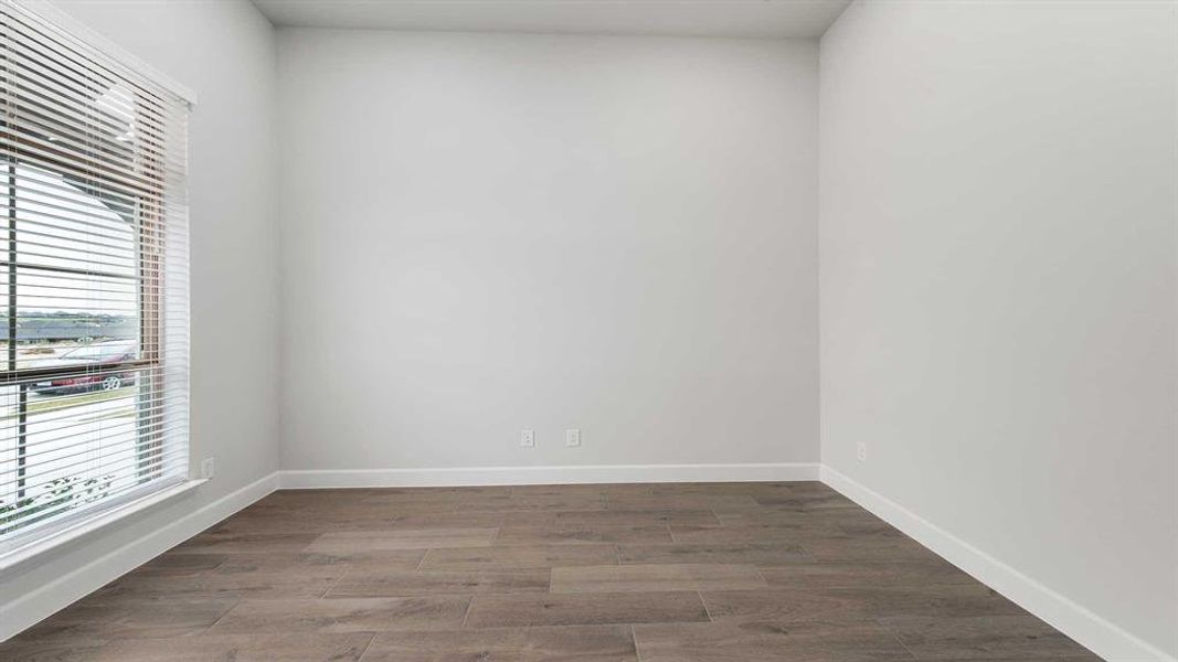 Empty room with hardwood / wood-style floors