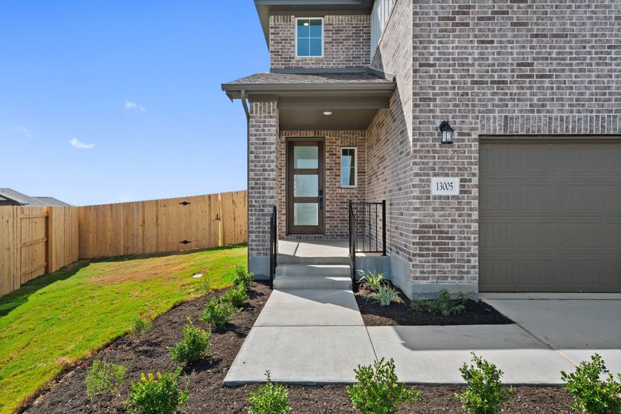 Exterior details and patio area of a home in Terrace Collection At Turner's Crossing, Buda (Image 3).