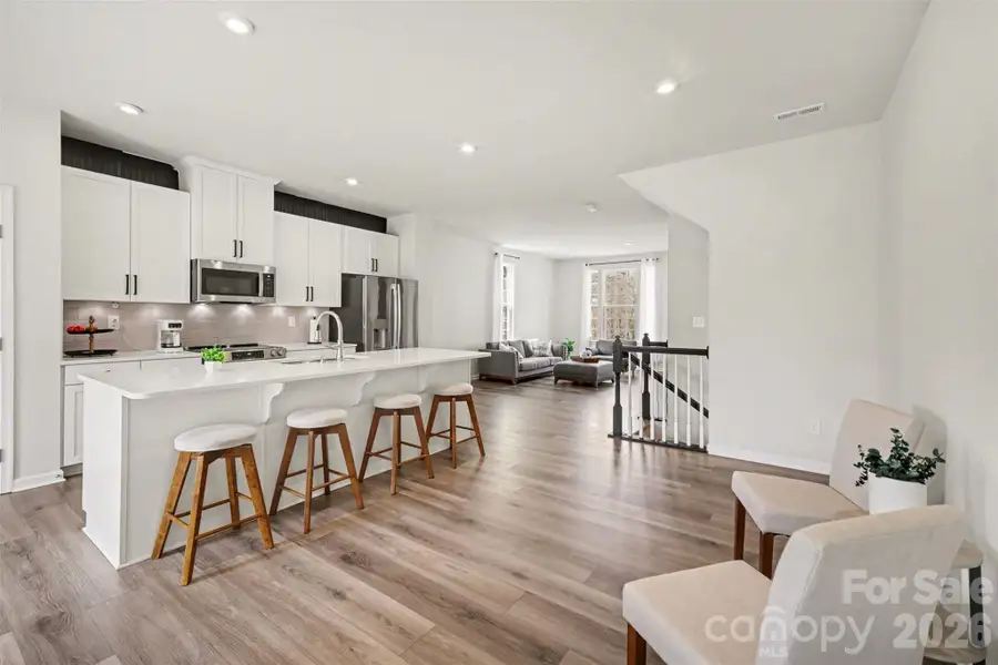 Bright open-concept kitchen featuring a large center island with seating.