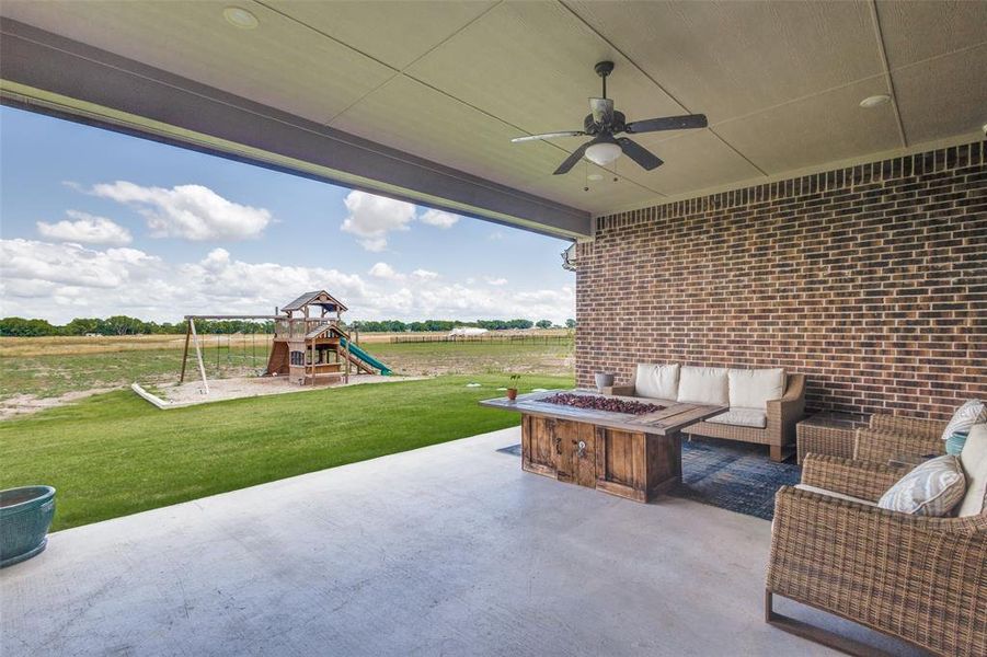 Expansive back patio offers a perfect spot to unwind while overlooking the spacious backyard of the one-acre lot, blending outdoor living with serene natural views.