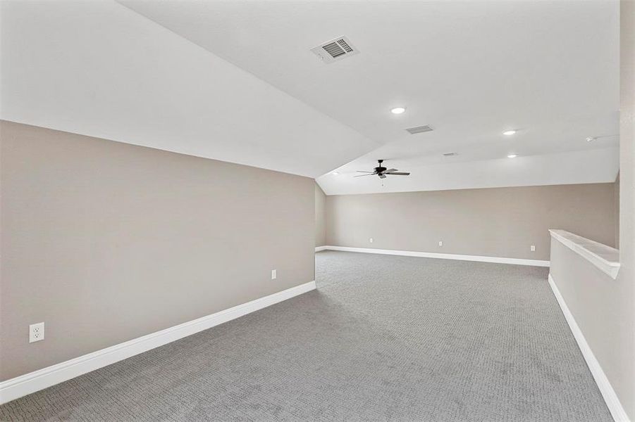 Bonus room with ceiling fan, carpet flooring, and lofted ceiling