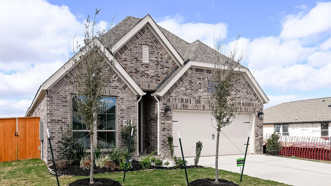 Front exterior of a new home in Crosswinds, Kyle, TX, highlighting curb appeal (Image 21).