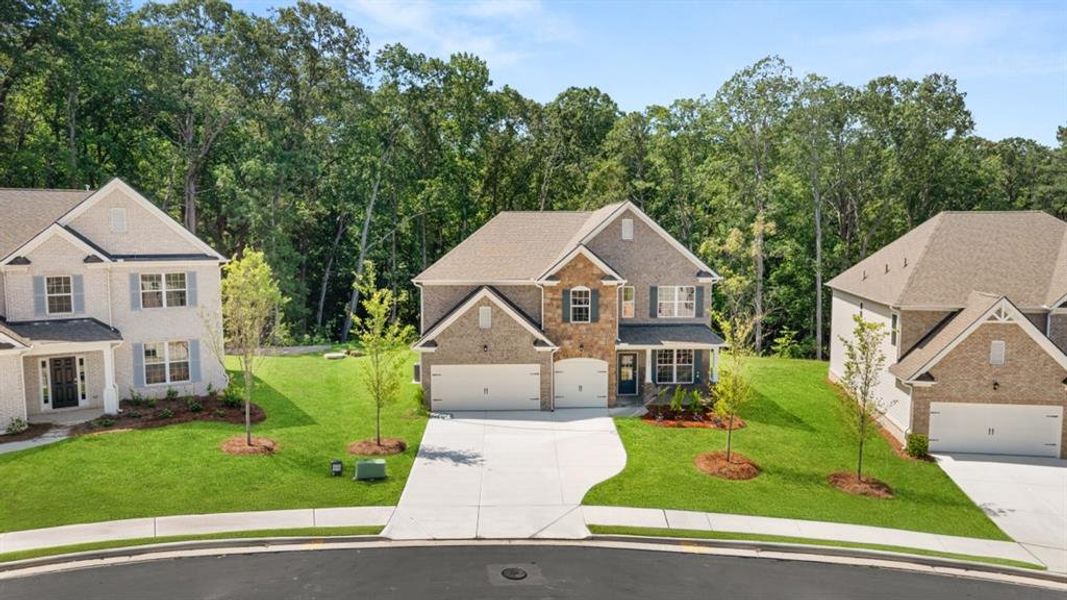 Front exterior of a new home in Holland Estates, Powder Springs, GA, highlighting curb appeal (Image 24). Front exterior of a new home in Holland Estates, Powder Springs, GA, highlighting curb appeal (Image 24).