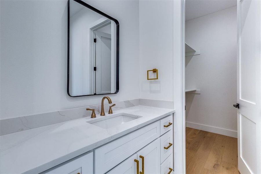 Bathroom featuring vanity and wood-type flooring