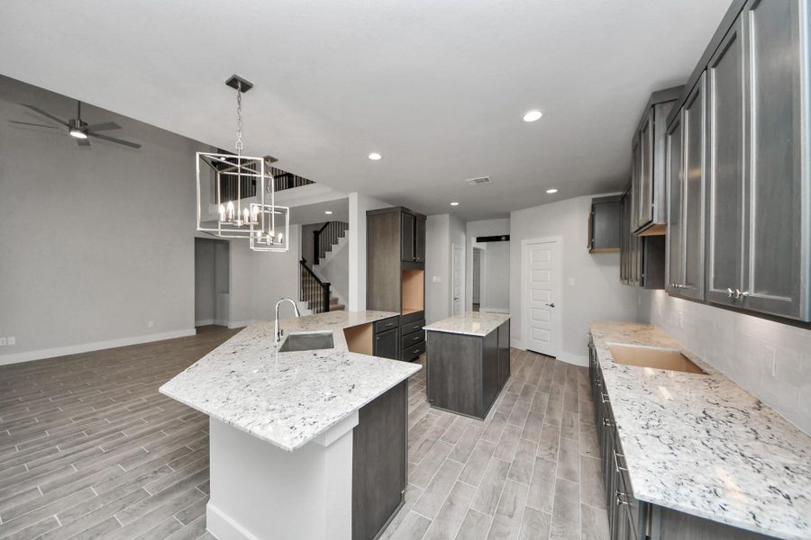 All of this overlooks your expansive family room, creating a perfect space for culinary delights and family gatherings.