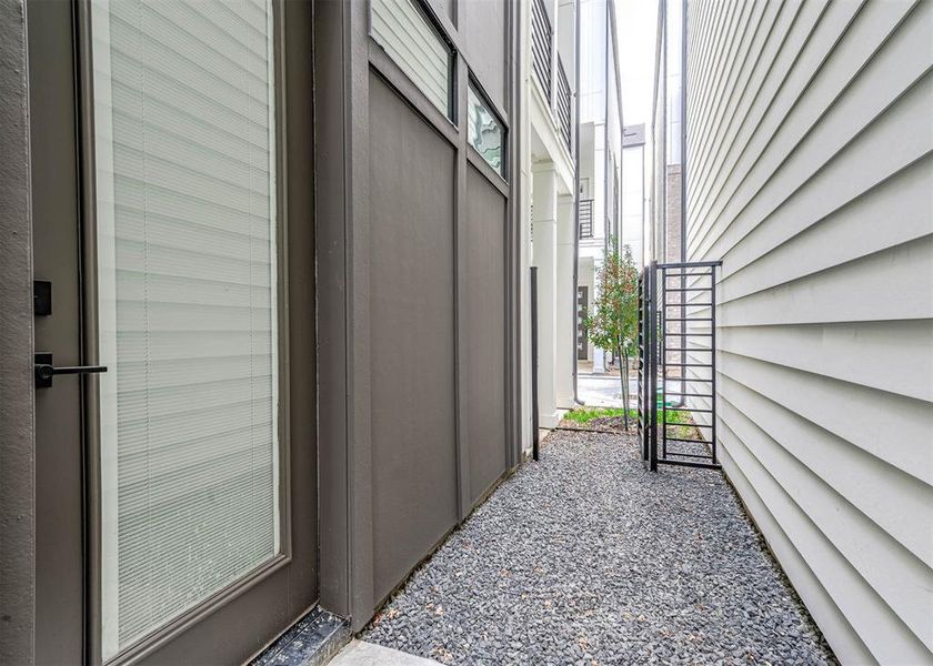 Fully gated outdoor space in the side of the home.