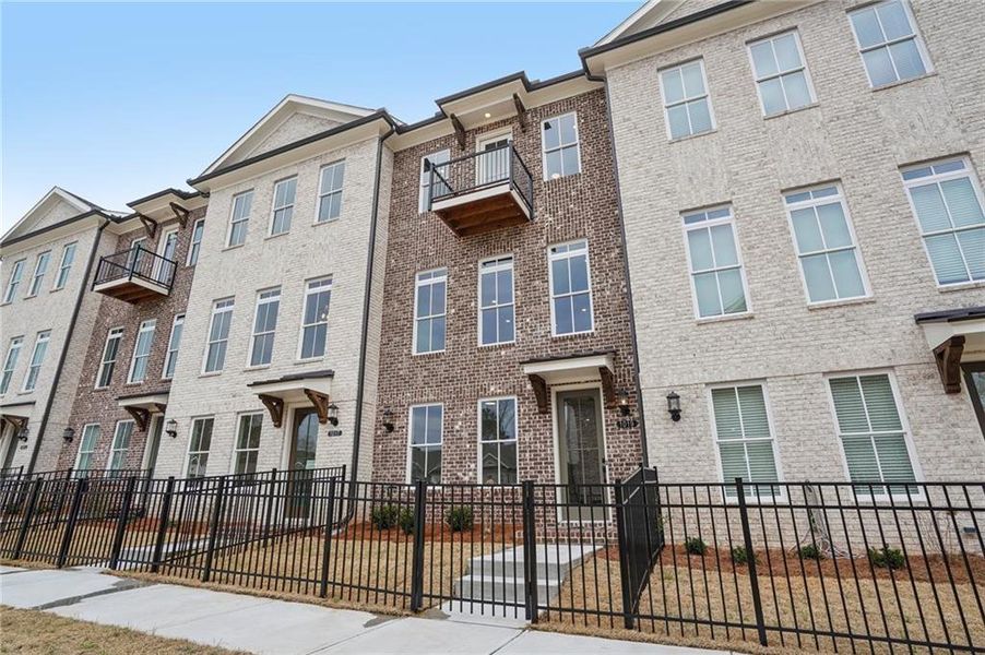 Exterior details and patio area of a home in Ward's Crossing Townhomes, Johns Creek (Image 19).