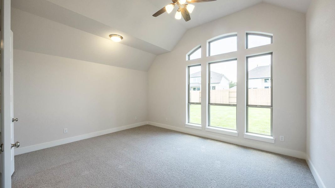 Bonus room with lofted ceiling, light carpet, and ceiling fan Bonus room with lofted ceiling, light carpet, and ceiling fan