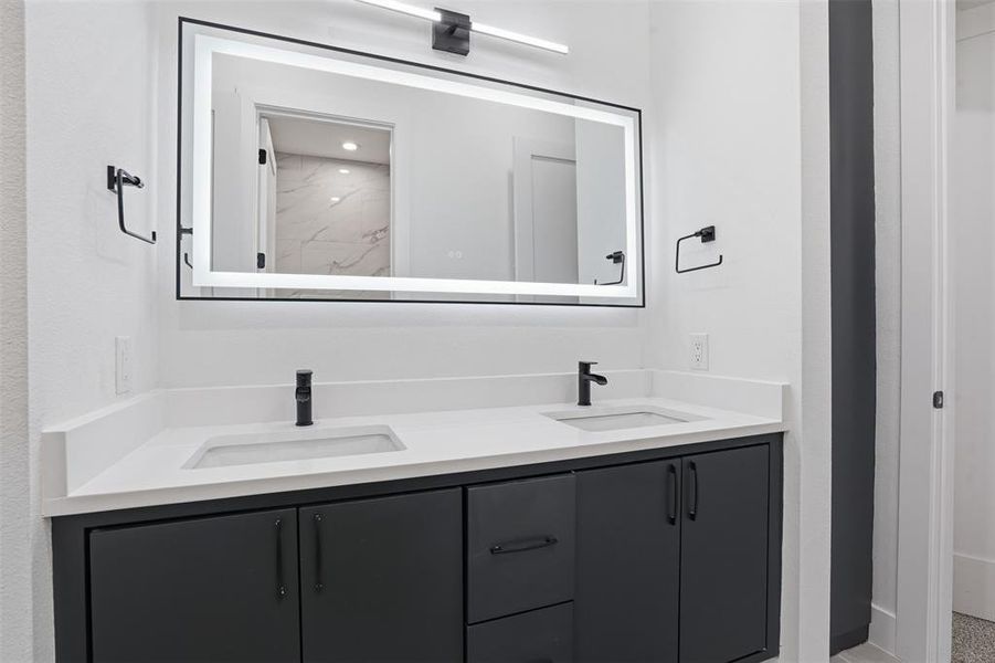 Dual vanity with white countertop and integrated sinks