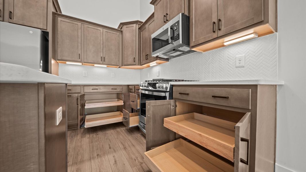 Elegant and compact island anchors this tasteful kitchen with high standards and timeless appeal