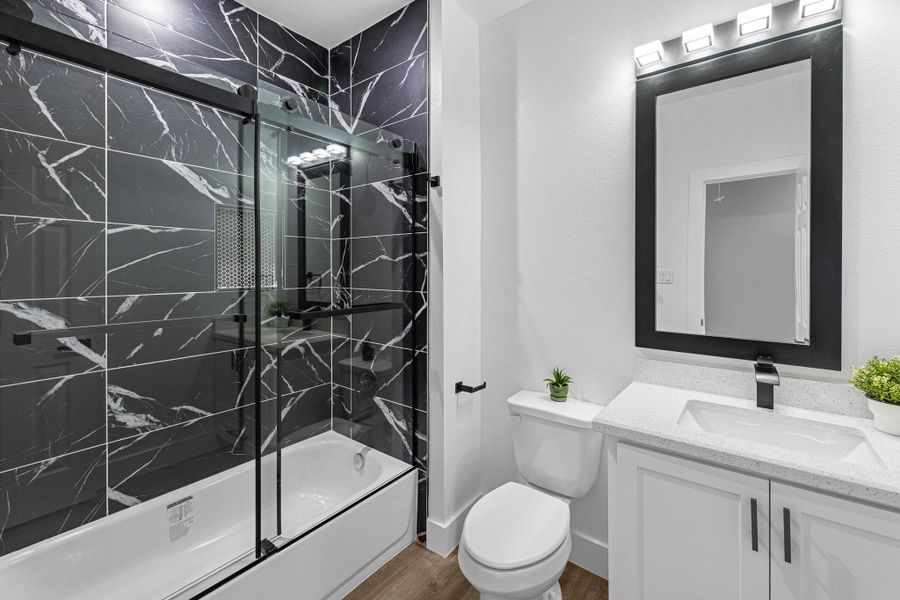 Bathroom #2 Hallway restroom. Tile shower, bathtub, granite countertops and modern fixtures. Mirrors were custom made.