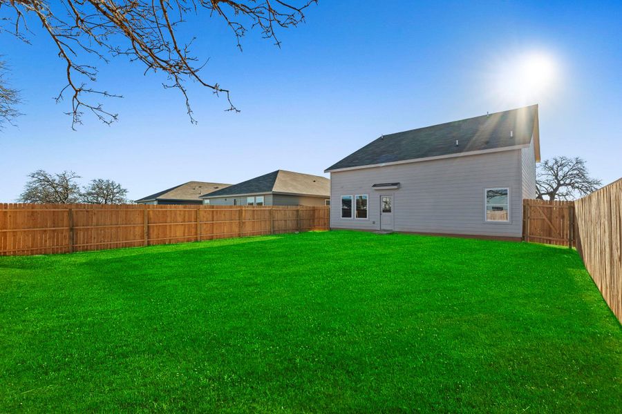 Exterior details and patio area of a home in Friendship Oaks, Fredericksburg (Image 2).