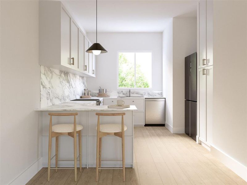 Kitchen with a kitchen bar, white cabinets, hanging light fixtures, and appliances with stainless steel finishes