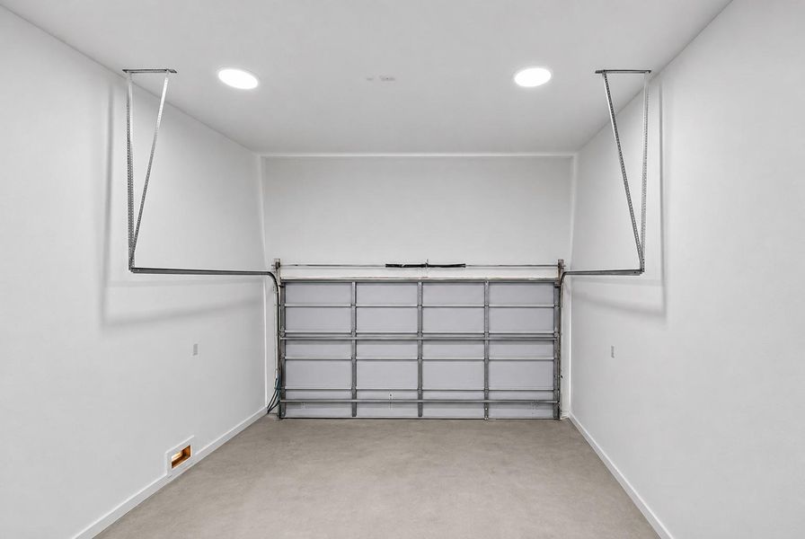 Attached 2-car garage with additional storage space. Attached 2-car garage with additional storage space.