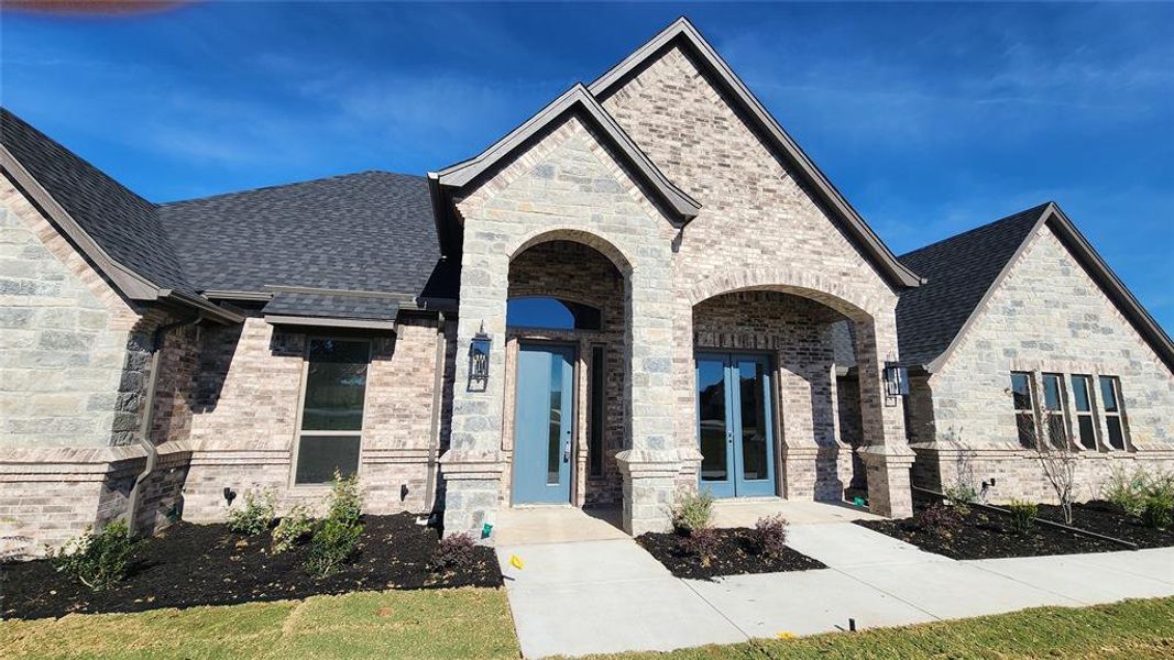 Front exterior of a new home in , Poolville, TX, highlighting curb appeal (Image 26). Front exterior of a new home in , Poolville, TX, highlighting curb appeal (Image 26).
