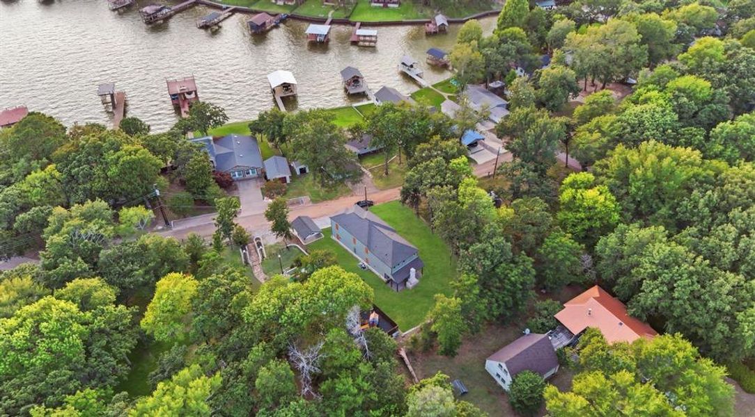 Aerial perspective showcasing a residential property with extensive surrounding greenery Aerial perspective showcasing a residential property with extensive surrounding greenery