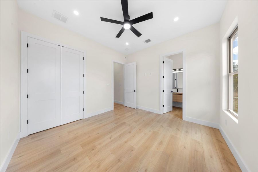 Unfurnished bedroom with recessed lighting, light wood-style floors, ensuite bath, a ceiling fan, and a closet Unfurnished bedroom with recessed lighting, light wood-style floors, ensuite bath, a ceiling fan, and a closet